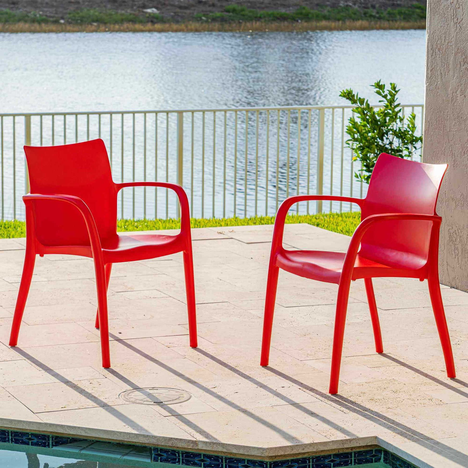 Red set of 2 outdoor stackable armchairs made of UV resistant resin reinforced with glass fiber