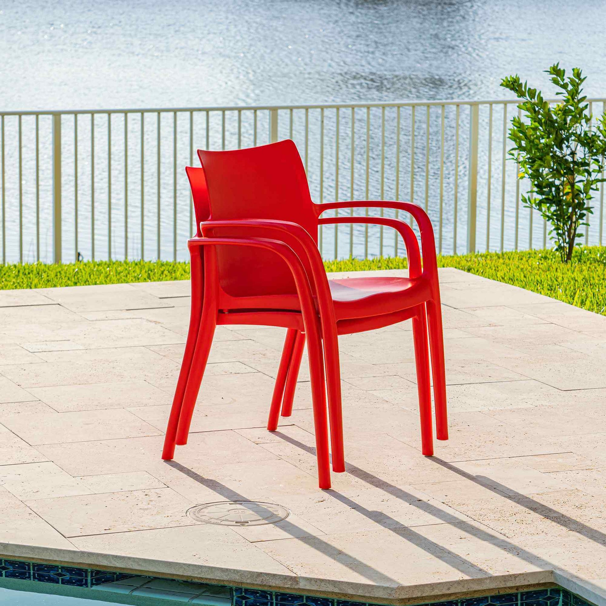 Red set of 2 outdoor stackable armchairs made of UV resistant resin reinforced with glass fiber