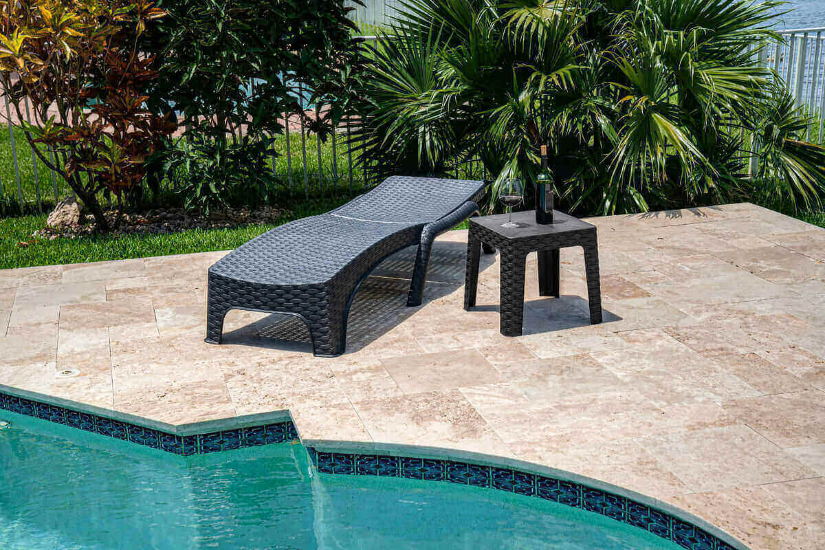 Black outdoor 3-piece chaise lounger set includes 2 stackable chaise loungers and an end table