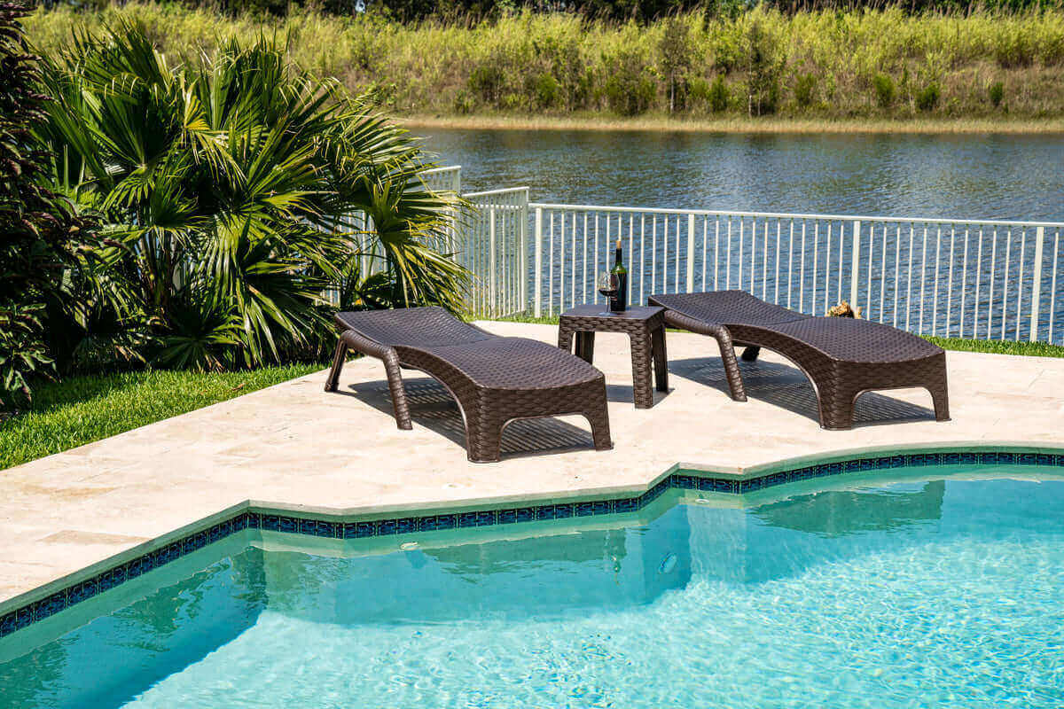 Brown outdoor 3-piece chaise lounger set includes 2 stackable chaise loungers and an end table