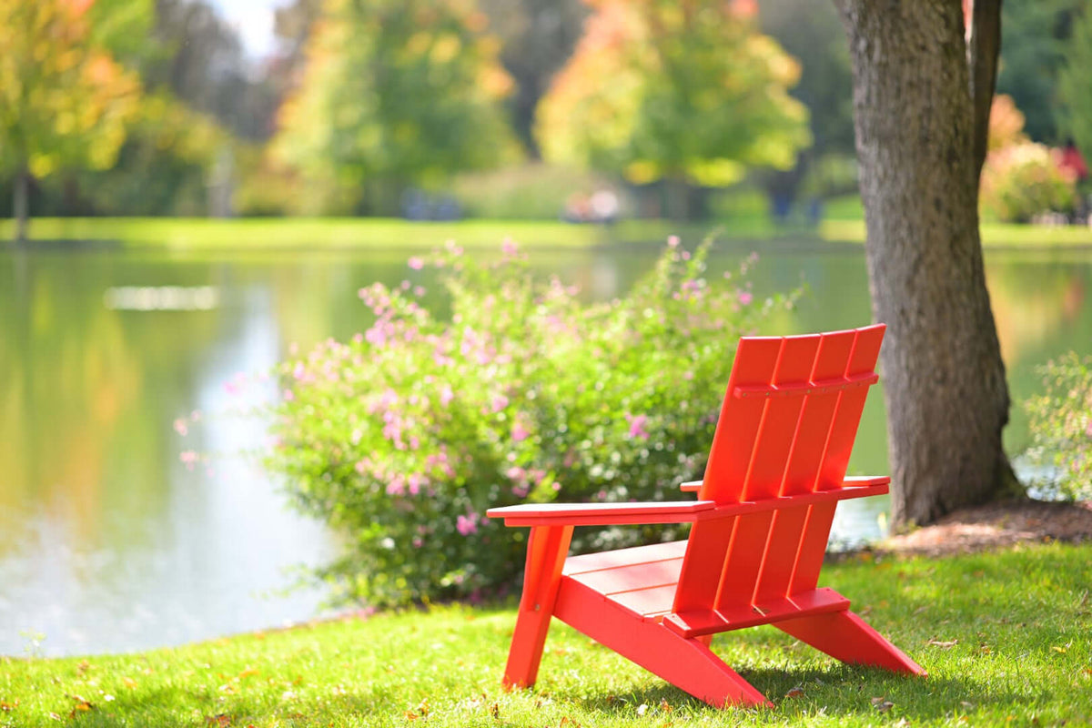 LuxCraft Urban Adirondack Chair in Red configured for porch seating — fade-resistant poly