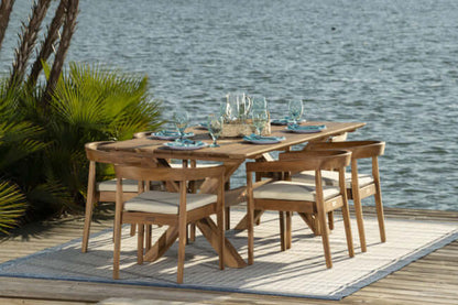 Panama Jack 7-piece outdoor rectangular dining table set made with Grade-A teak wood for a natural wood finish with cushions